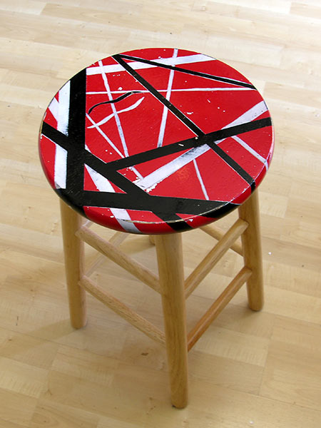 Wooden stool painted with Eddie Van Halen's guitar stripe